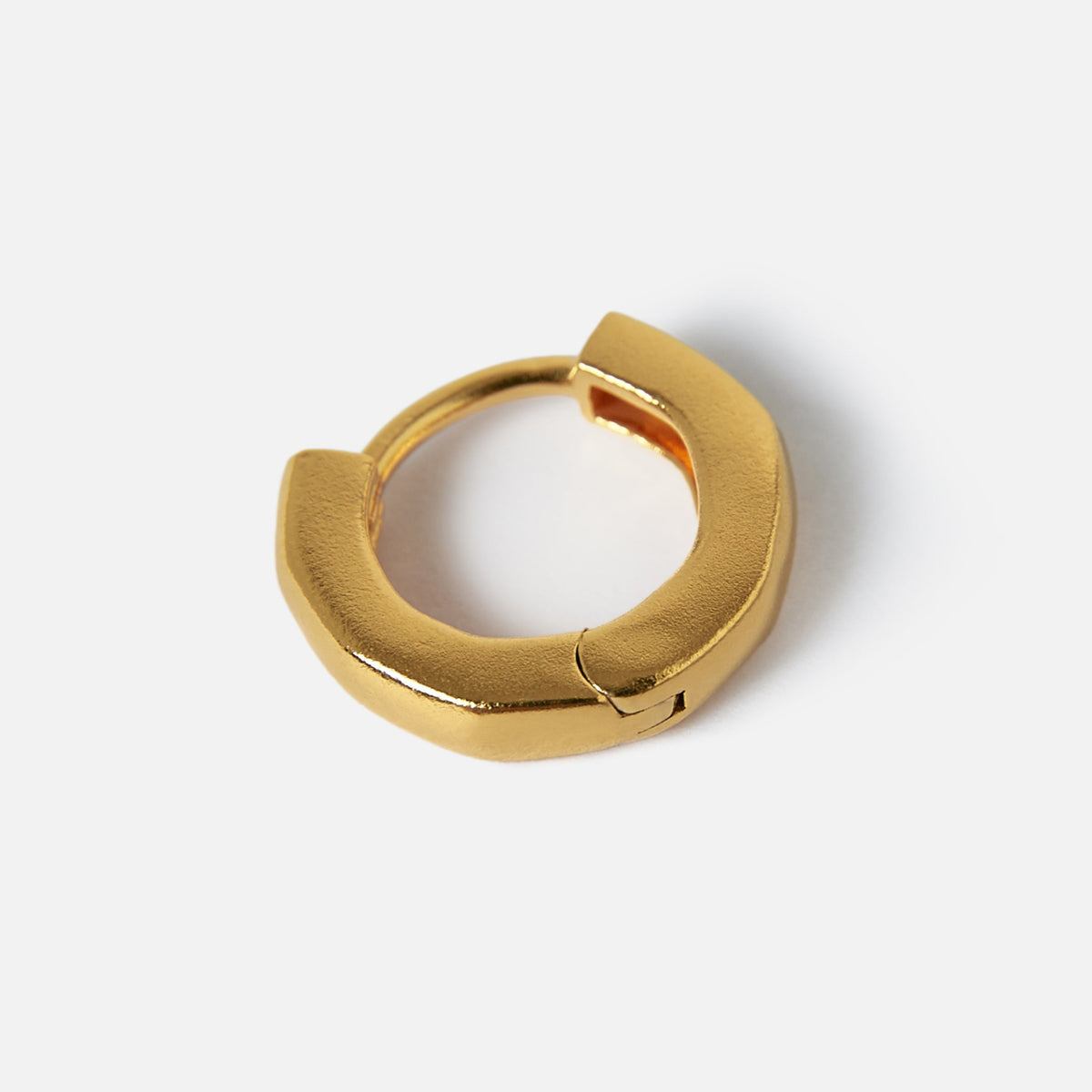 A single 18k gold vermeil Lumina Earring from Billie Jo, laid flat to showcase its unique shape and minimalist design on a white background.