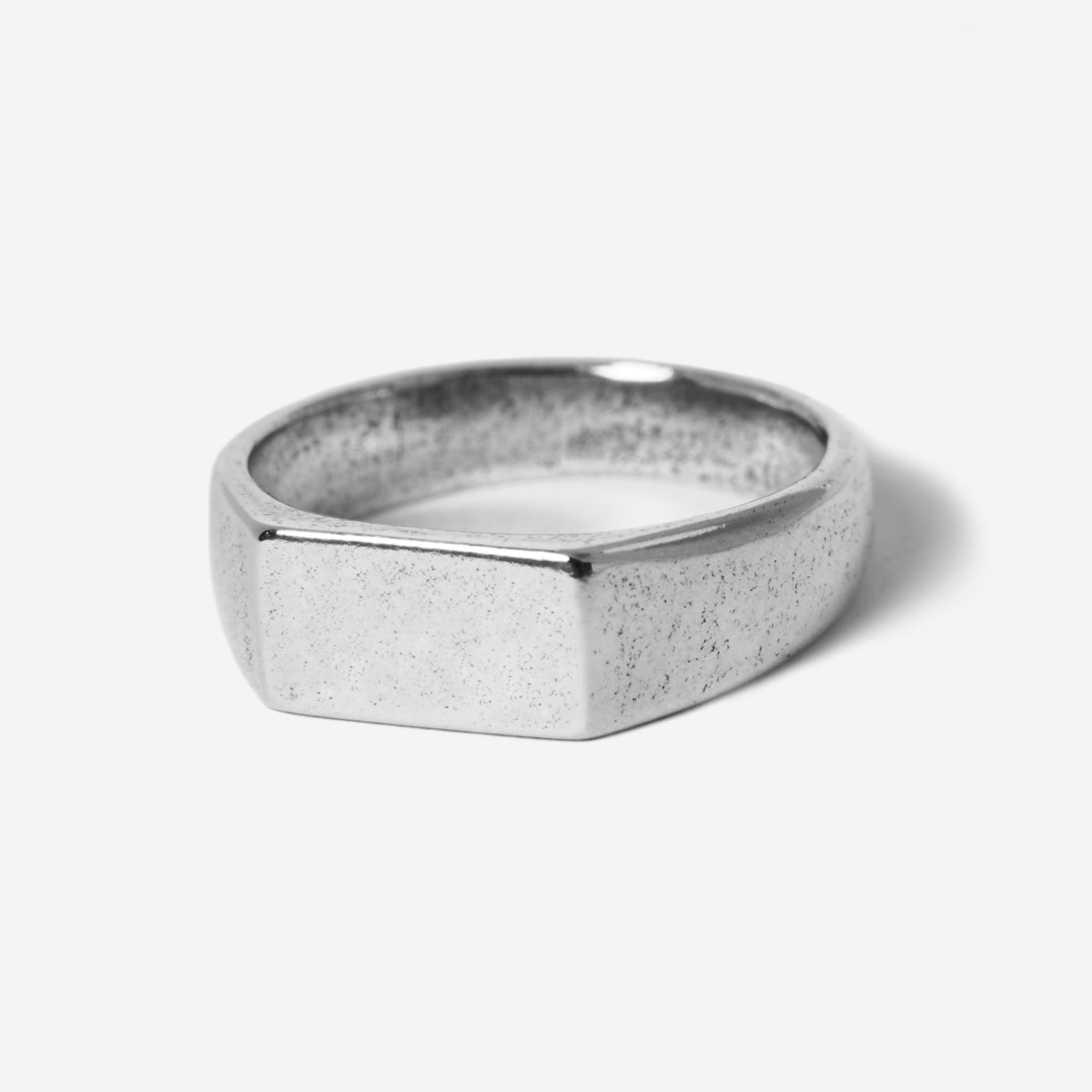 A modern men's signet ring, the Billie Jo Genesis Ring in sterling silver features a rectangular face and a unique textured finish. A timeless piece of Australian men's jewellery.