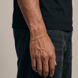 Gold stainless steel curb bracelet on mans wrist