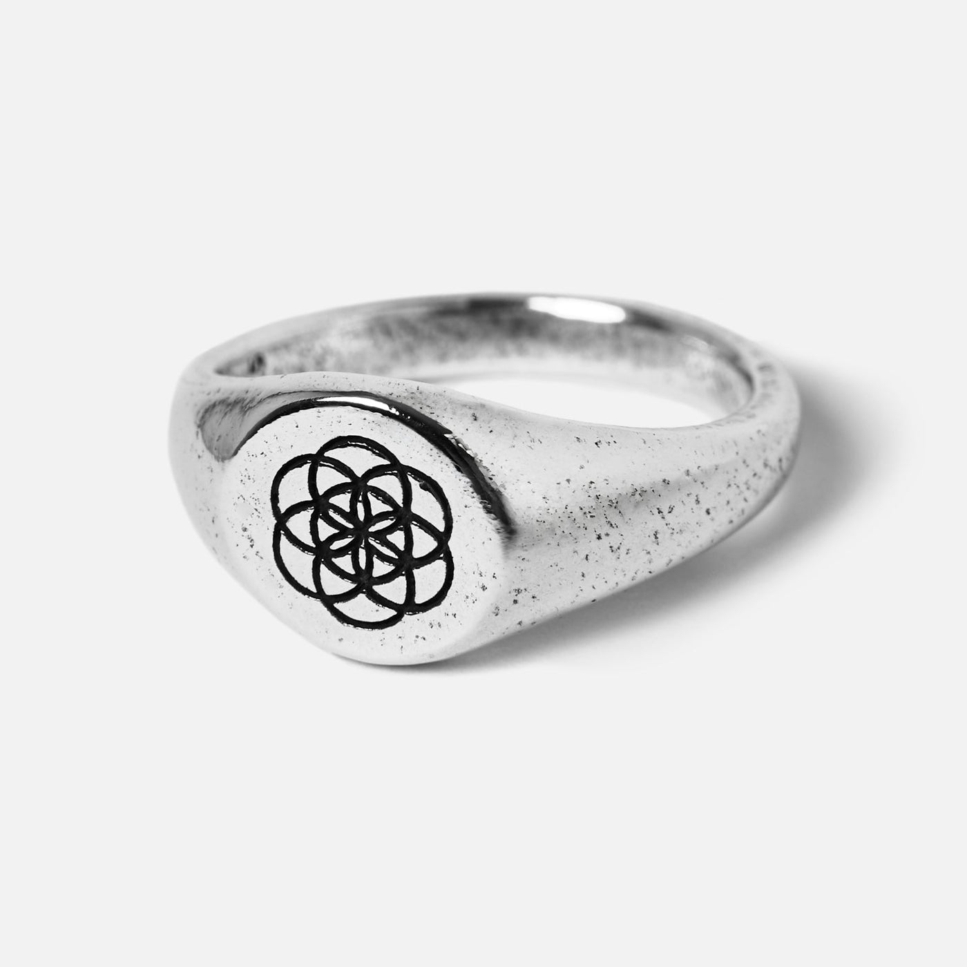 Billie Jo's UNITY RING in 925 sterling silver, a men's signet ring with a detailed geometric flower of life pattern and a unique textured finish.