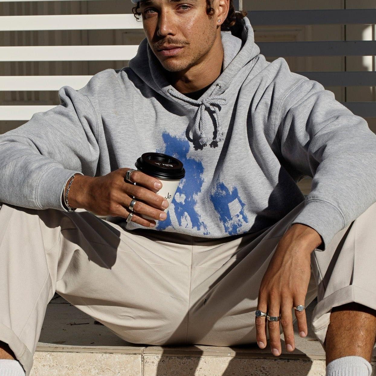 A man's hands with multiple rings, including the Solace Ring, in a relaxed pose. Showcasing the versatility of Billie Jo's men's jewellery collection.