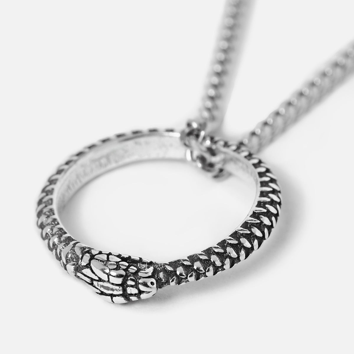 Detailed shot of the Billie Jo Ouroboros Pendant in sterling silver, highlighting the intricate snake head and scale details against a clean white background.