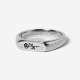 A sterling silver signet ring, the Rosa II by Billie Jo, featuring a delicate, engraved rose design on its face. A modern, masculine piece of Australian jewellery.