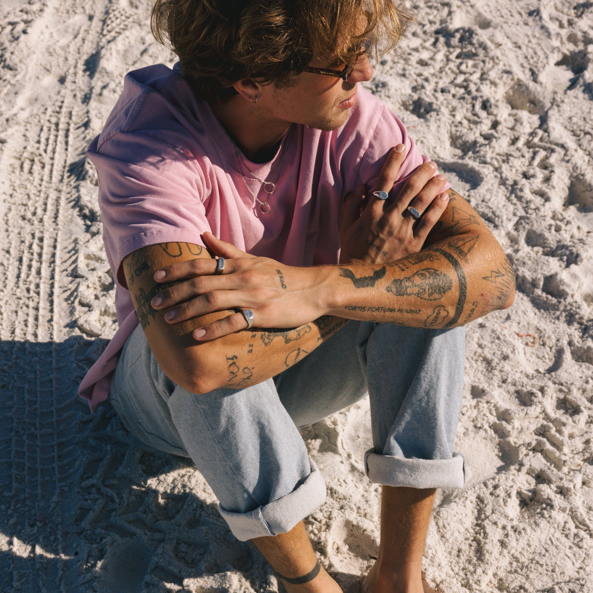 A man wearing the BE KIND ring as part of his daily jewellery stack, showing how it complements a relaxed, coastal aesthetic. From Australian brand Billie Jo.