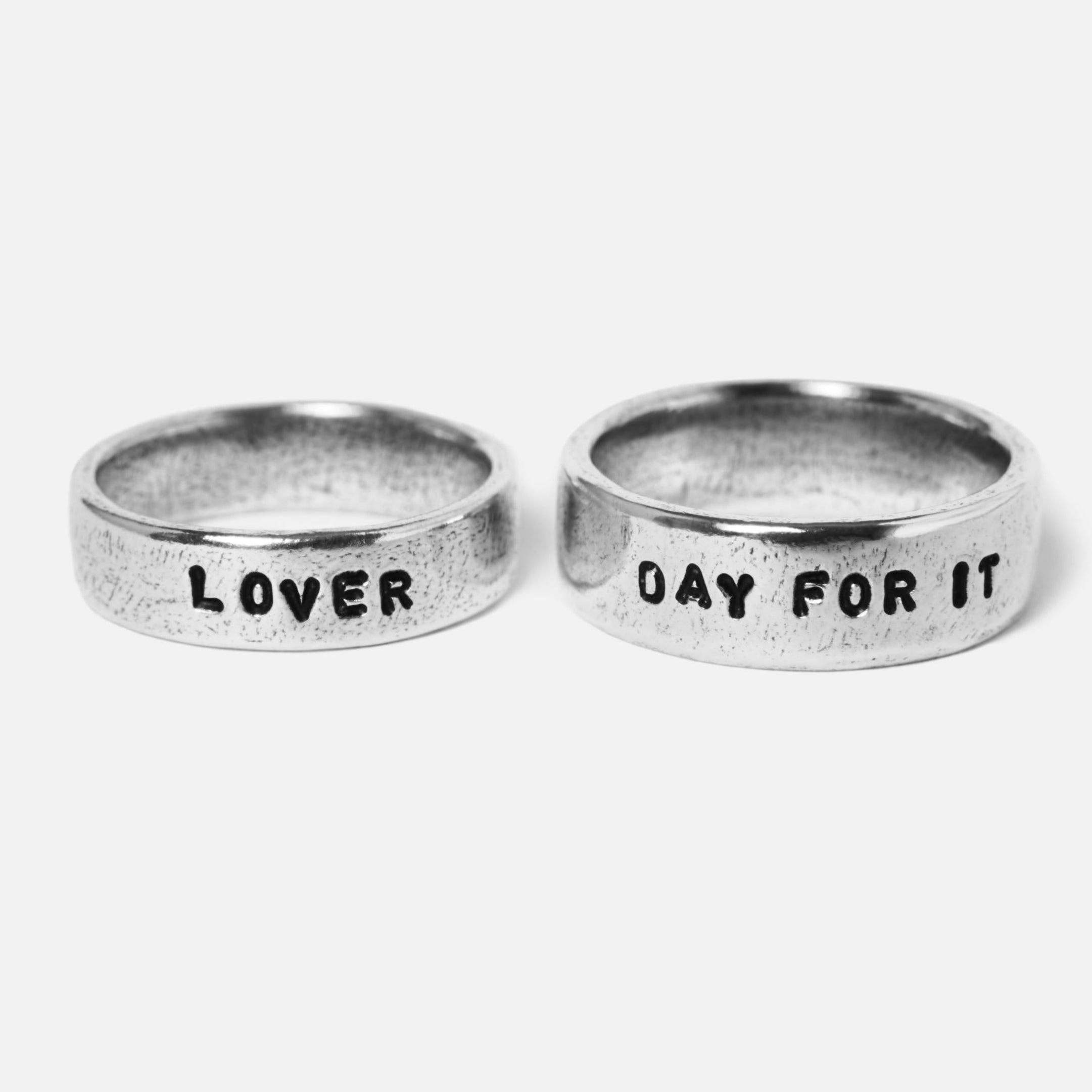 Two sterling silver Custom Stamped Rings by Billie Jo, engraved with '''LOVER''' and '''DAY FOR IT''', showcasing personalised Australian men's jewellery.