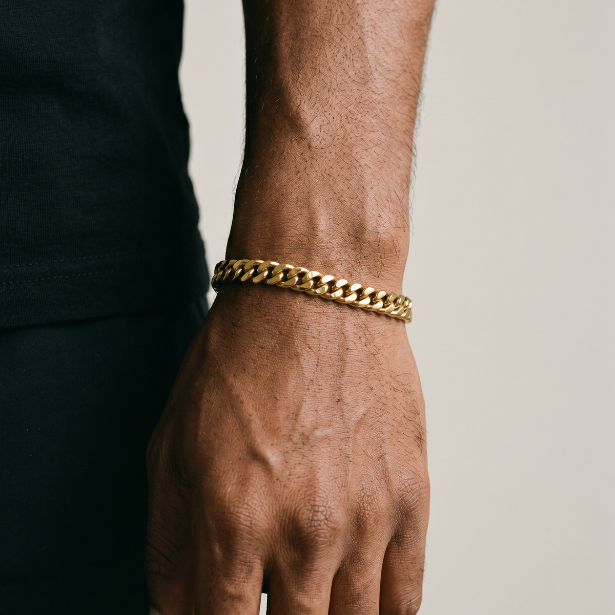 A man wearing a gold stainless steel bracelet layered - from Australian jewellery brand Billie Jo, styled for everyday casual wear.
