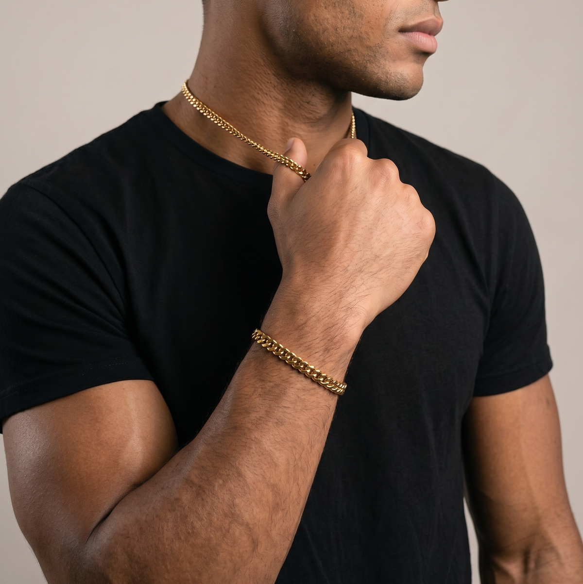 A man wearing a gold stainless steel bracelet and necklace set- from Australian jewellery brand Billie Jo, styled for everyday casual wear.