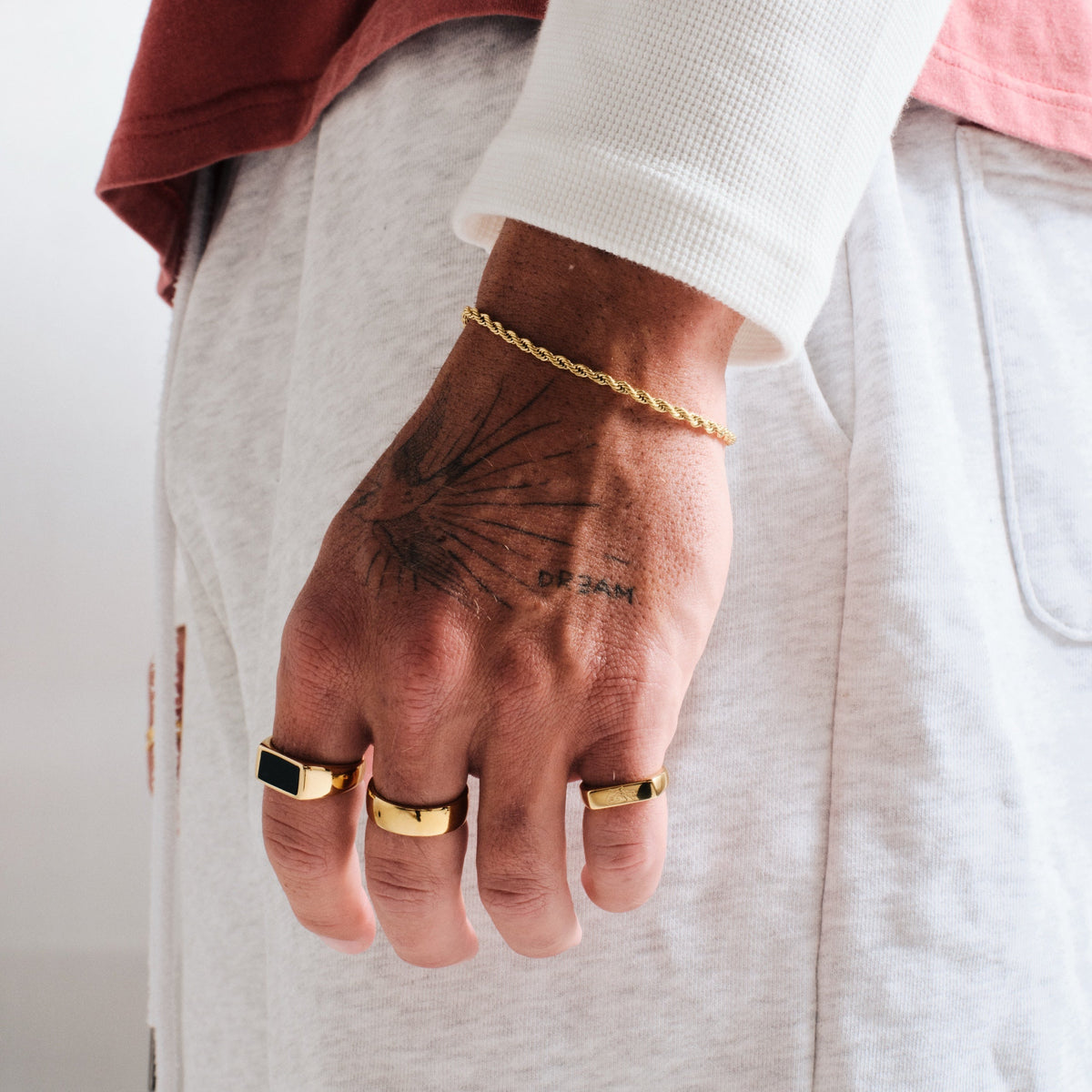 Men's Gold Canvas Ring in 18k gold infused stainless steel, worn on the middle finger, hand by his side