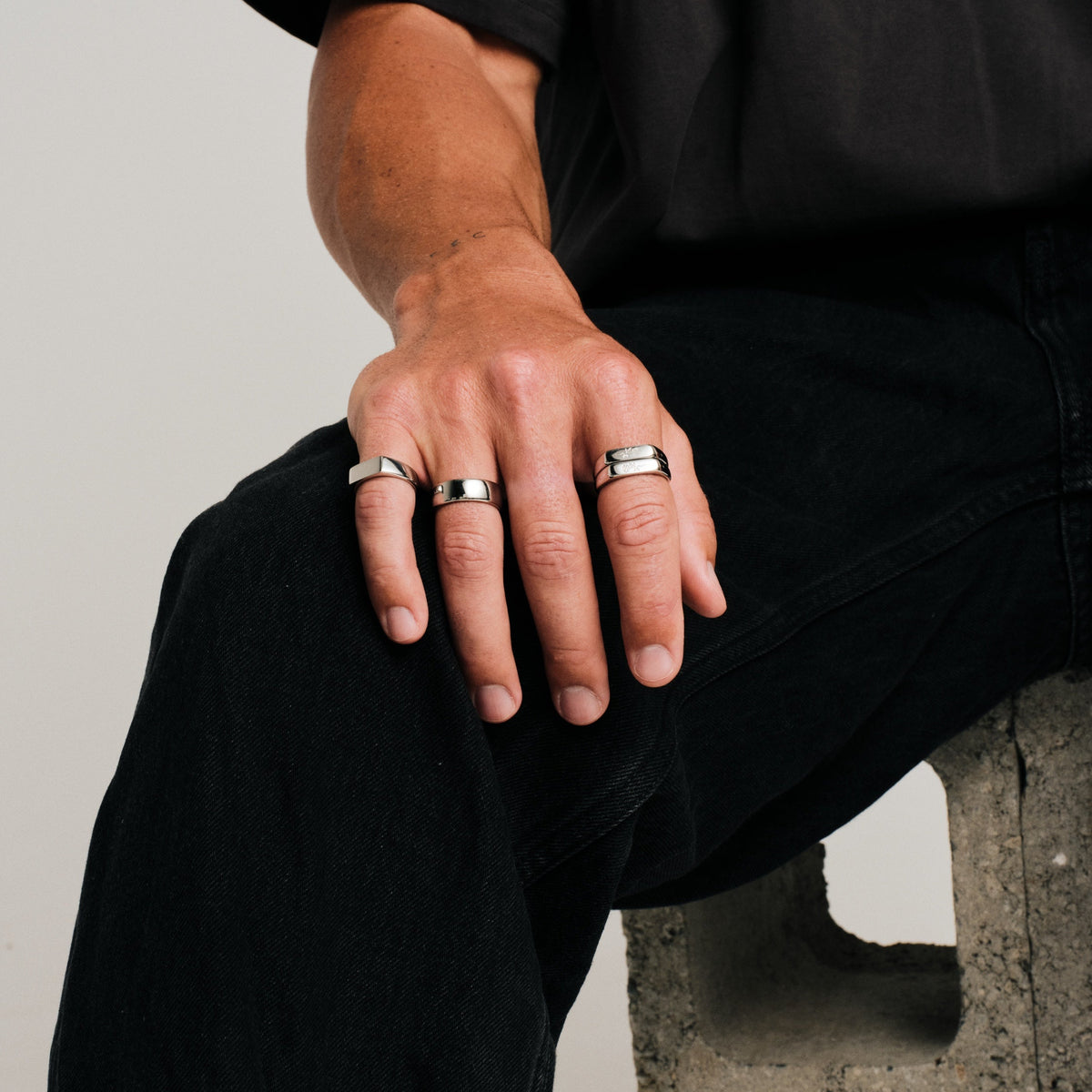 Men's Genesis Ring in 316L stainless steel, silver finish, worn on the little finger, black tee, black jeans