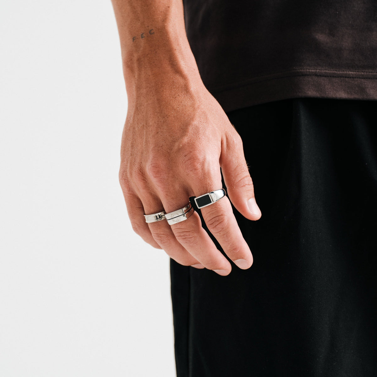 Men's Onyx Ring in 316L stainless steel, silver finish, worn on his right index finger, hand hanging by his side