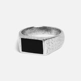 A studio shot of the silver Onyx Ring from Billie Jo. The ring has a rectangular black onyx stone and a textured sterling silver band.