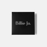 Stacked Billie Jo rings with raw textures and soft light reflections.