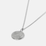 A sterling silver men's Untold Pendant from Billie Jo, featuring a round, textured, flat pendant on a silver chain, shot against a white background.
