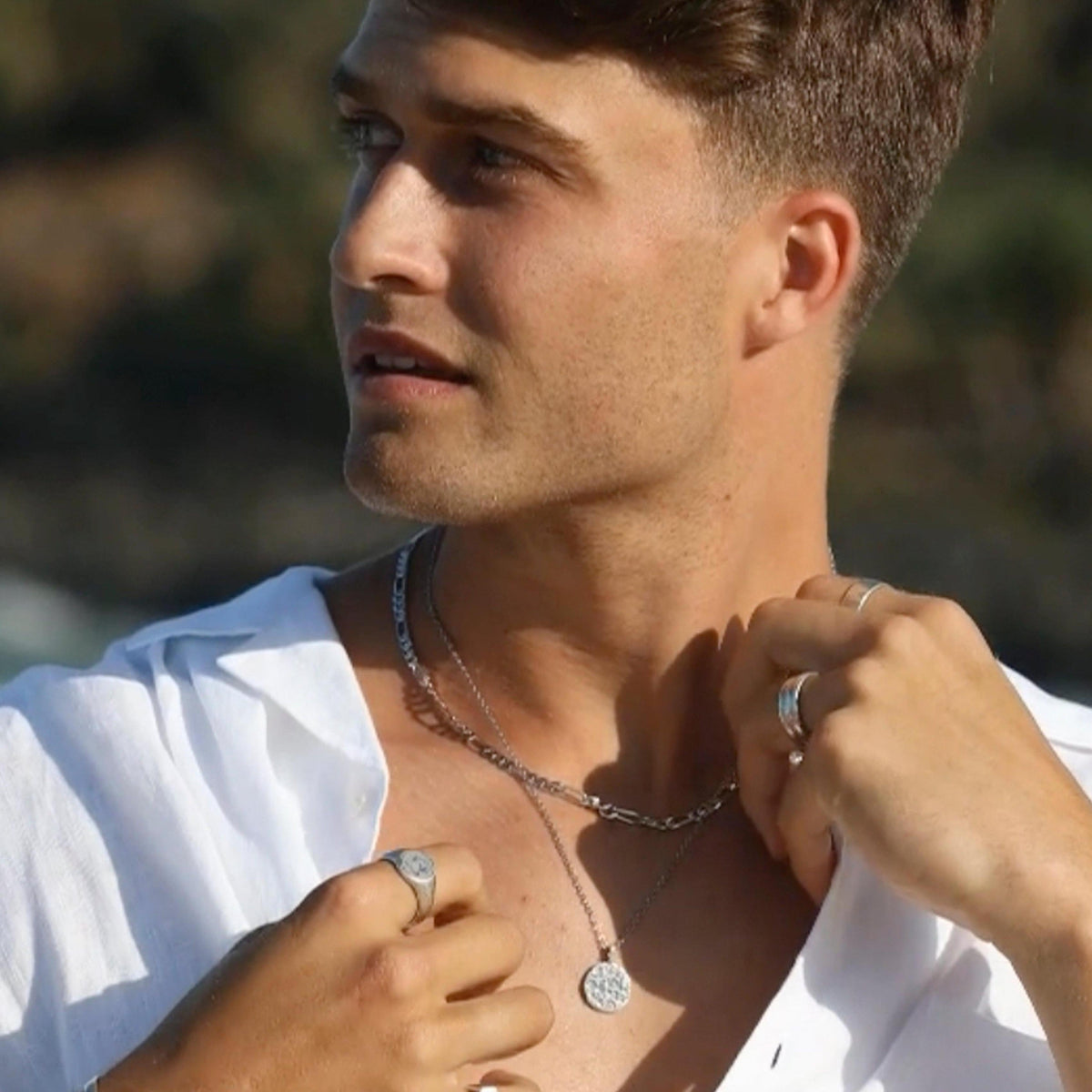 Close-up of a man wearing the Billie Jo Figaro Necklace layered with another silver chain. This image showcases how to style this versatile piece of men's jewellery.
